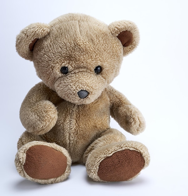 old brown teddy bear on a white background