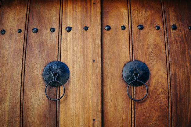 Old brown wooden doors with rings