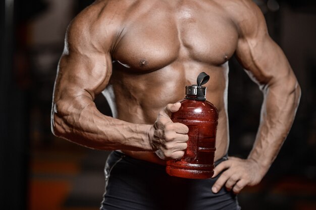 Old brutal strong bodybuilder athletic men pumping up muscles with dumbbells