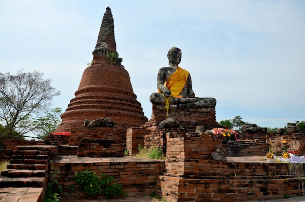 Old buddha statue and ancient building at Wat Worachet Tharam temple at Ayutthaya historical park in Ayutthaya Thailand