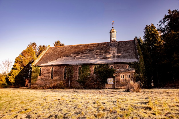 Old building on field against clear sky