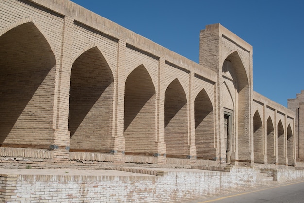 The old building, the wall with arches. Ancient buildings of medieval Asia. Bukhara, Uzbekistan