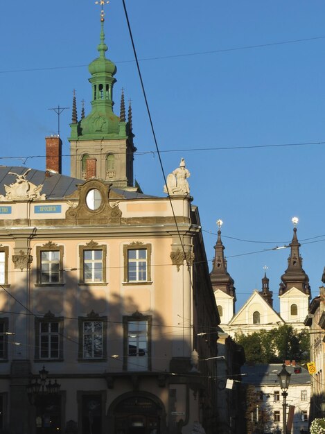 Old building with windows of a European city and gothic domes of churches against the blue sky