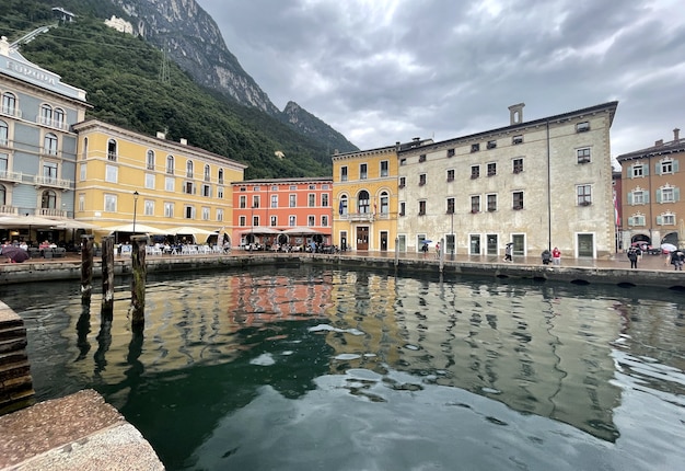 Old buildings in the harbour of riva del garda lake in italy