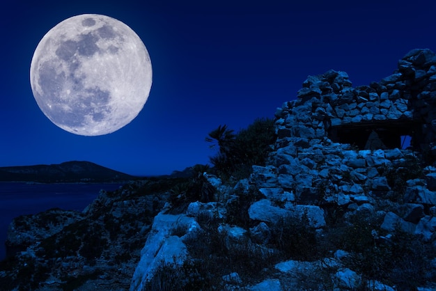 Old bunker on the coast with super moon