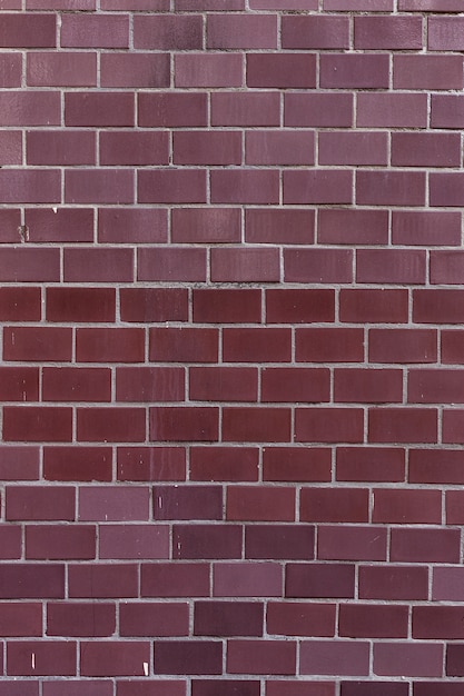 Old burgundy tile on the wall, rustic background.