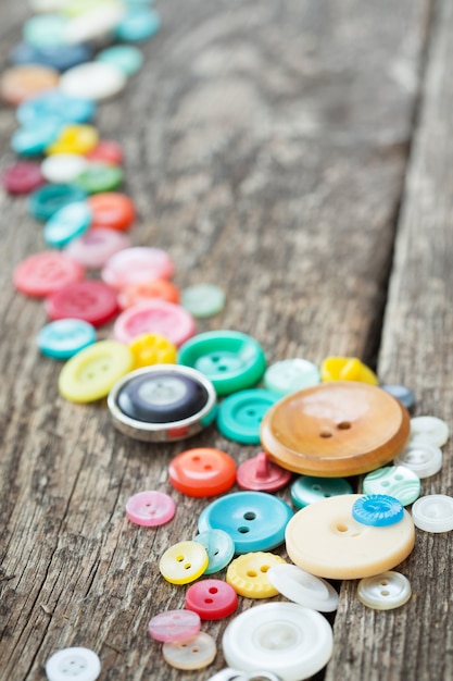 Old buttons on wooden boards