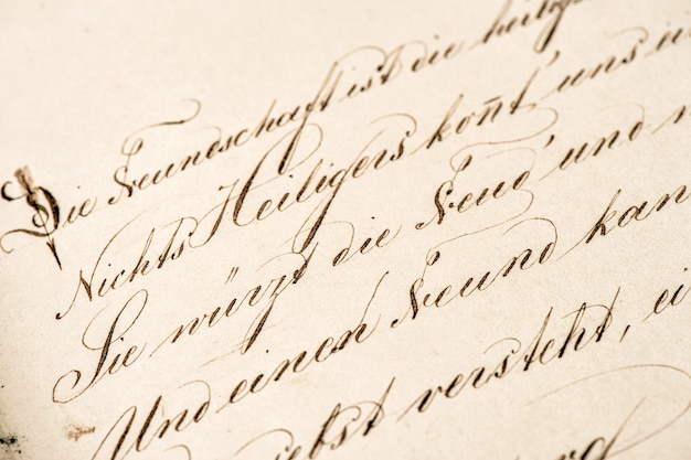 Foto vecchia calligrafia calligrafica. fondo di struttura di carta dell'annata di lerciume