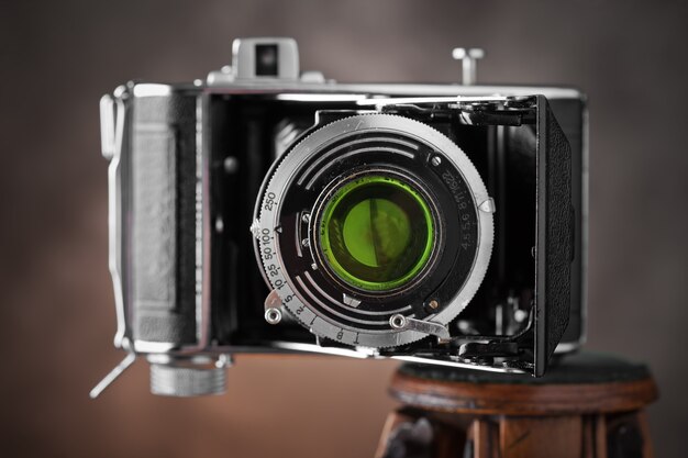 Old camera on an old background on a close-up table