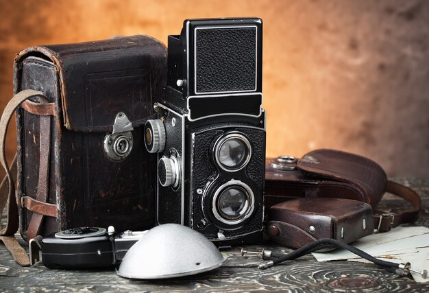 Old camera on an old background on a close-up table