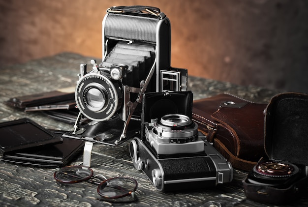 Old camera on an old background on a close-up table