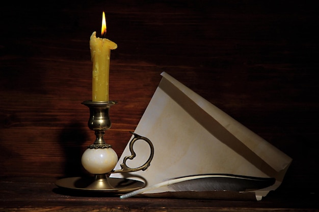 Old candle on table in room