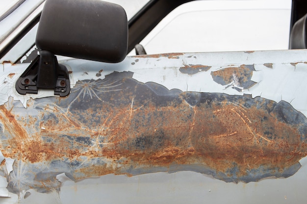 Old car door, damaged surface.