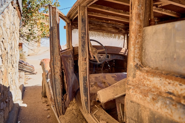 Old car with rust abandoned on the street