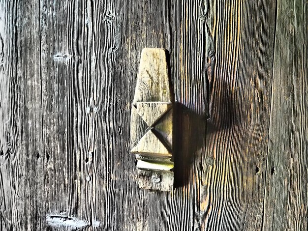 Old carved wooden doorknob a traditional rustic pattern or ornament carved with a knife on a wood