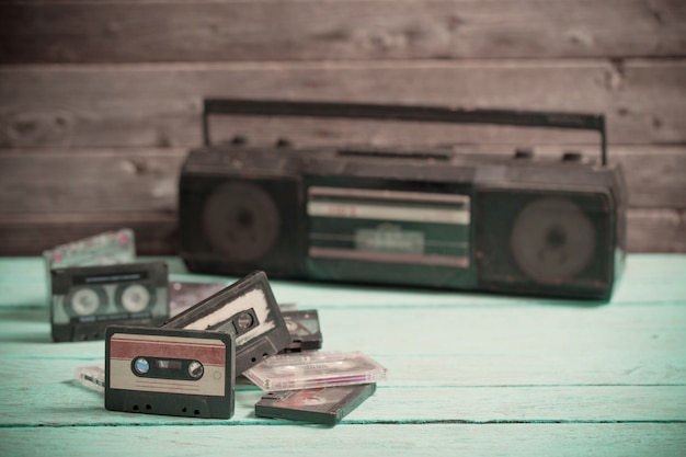 Old cassette tape and player on the wood