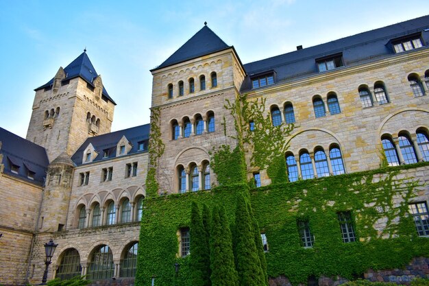 Old castle made of grey brick with towers high windows with a blue roof Poland Poznan