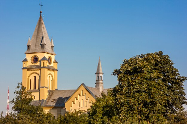 Old cathedral surrounded by trees in Ivano-Frankivsk city