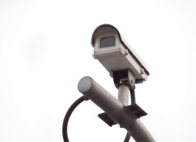 Old CCTV security camera on a high pole