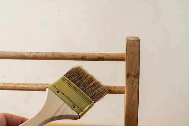 Old chair on a white background. Recycle, renovation, painting