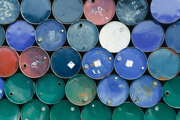 Old chemical barrels. Blue, green, and red oil drum. Steel oil tank. Toxic waste warehouse.