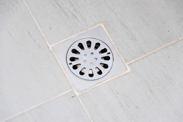 Old chrome shower drain set in on a shower