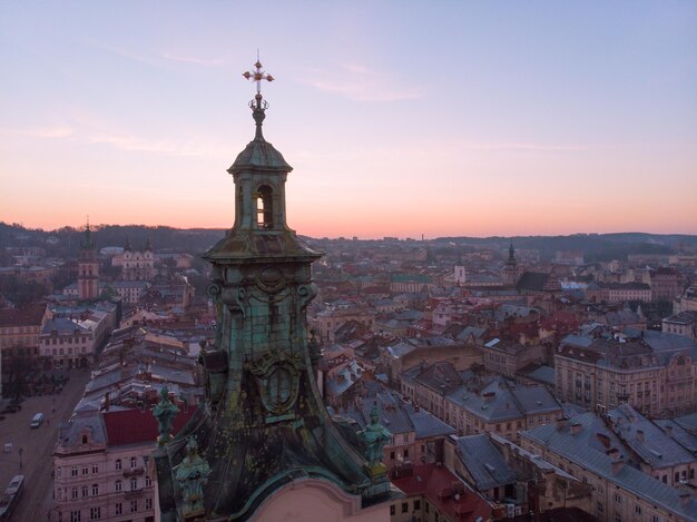 Old church tower with sunrise on background. european cityscape aerial view