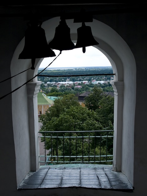 Photo old church window with bell silhouettes