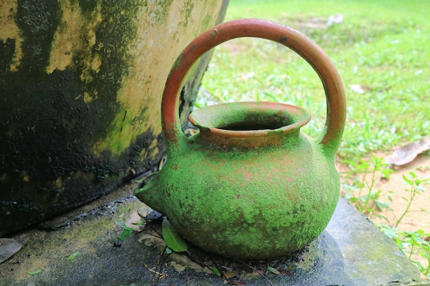 Old clay pot with moss cover. Object and vintage concept