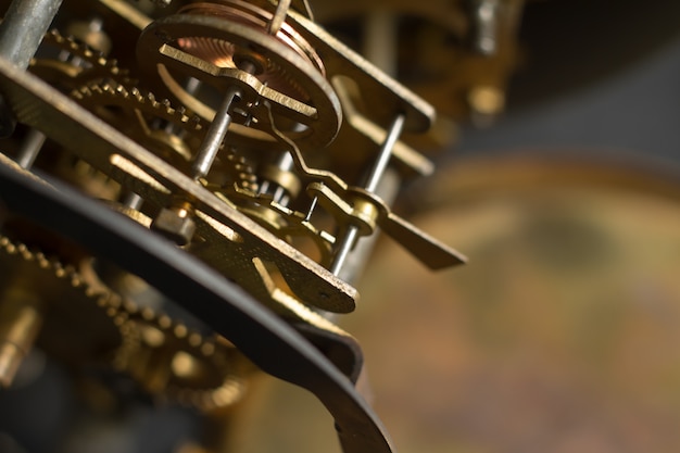 Old clock mechanism with gears and cogs. Selective focus.