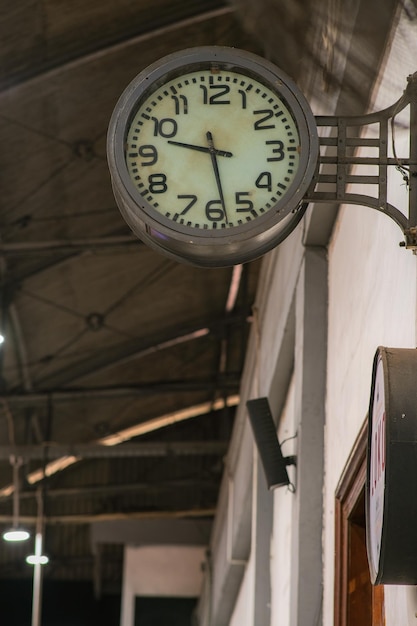 An old clock in one corner of a railway station in Yogyakarta