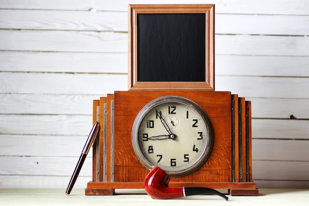 Old clock and smoking pipe