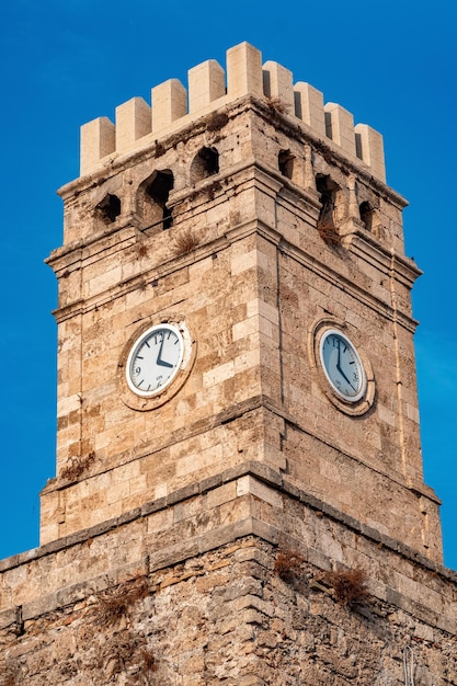 Old clock tower against the sky closeup