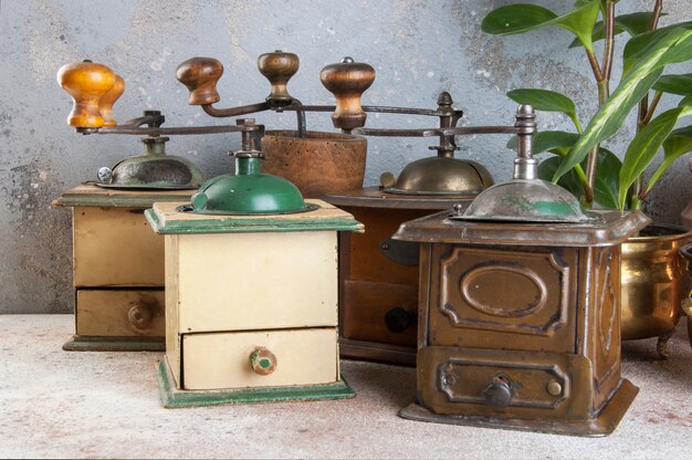 Old coffee grinders on concrete background. 