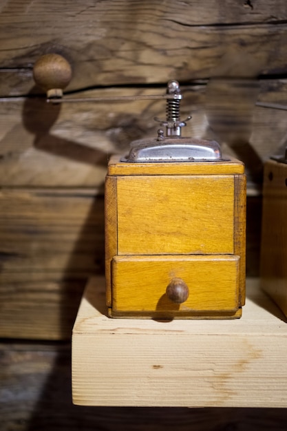 old coffee mill on wooden table