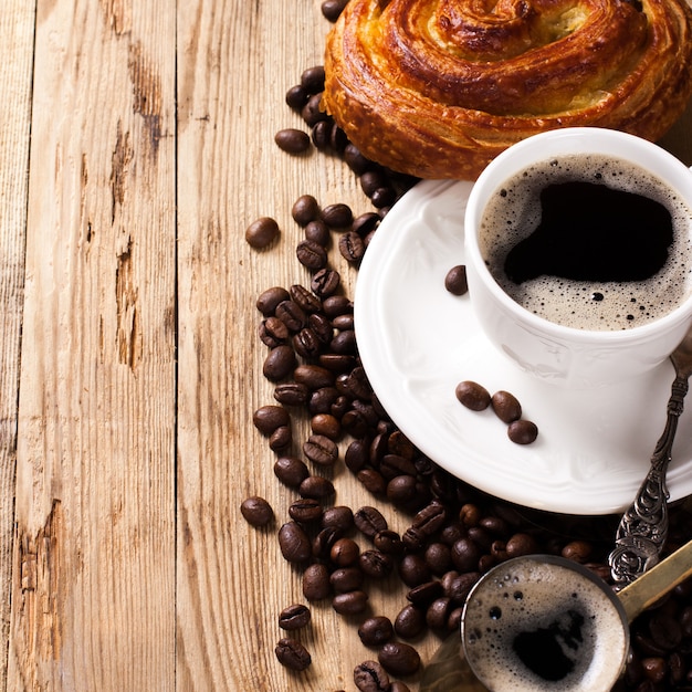 Old coffee pot and cup on wooden rustic background