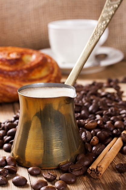 Old coffee pot on wooden rustic background