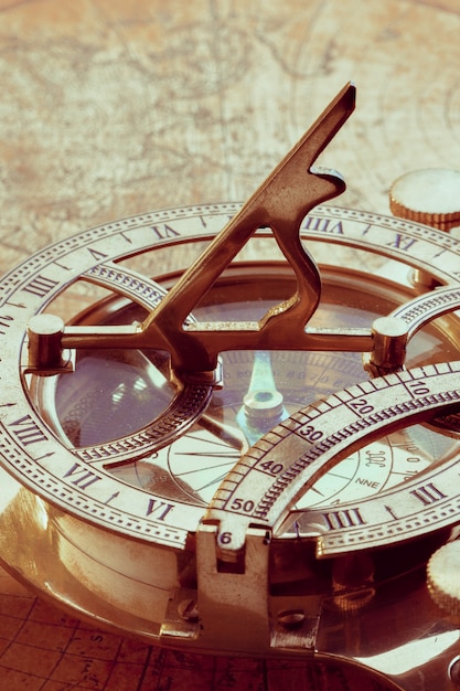 Old compass over ancient map