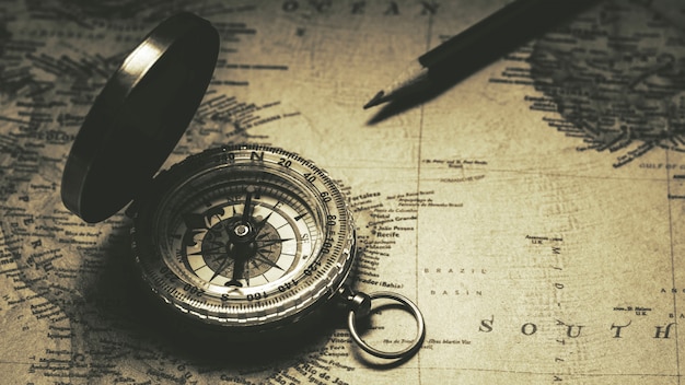 Old compass on antique map. - vintage background style.