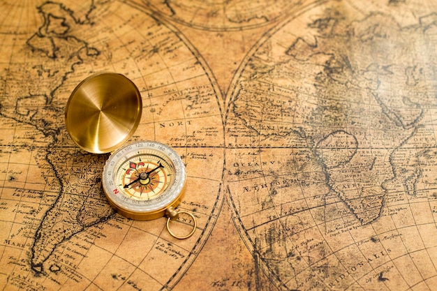 Photo old compass on vintage map