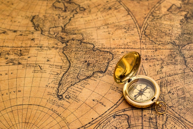 Old compass on vintage map