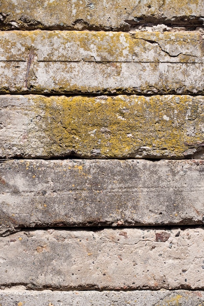 古いコンクリートブロック壁の背景のクローズアップ