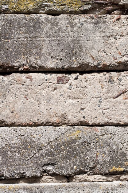 Old concrete blocks wall background closeup