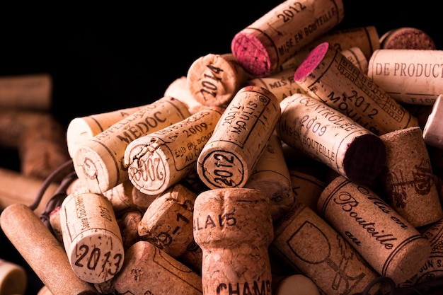 Photo old cork stoppers of french wines in a wire basket