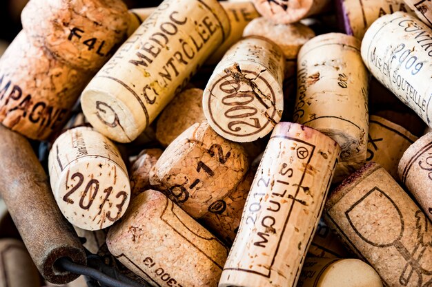 Old cork stoppers of French wines in a wire basket