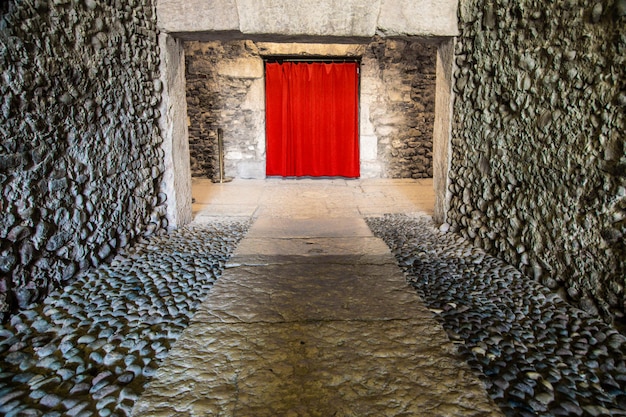 Old corridor with red curtain at the end Concept for mystery gothic escape hope