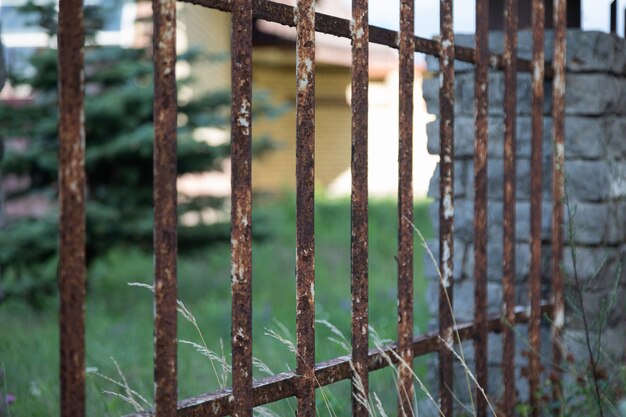 Old corrosed metal fence in countryside's country house