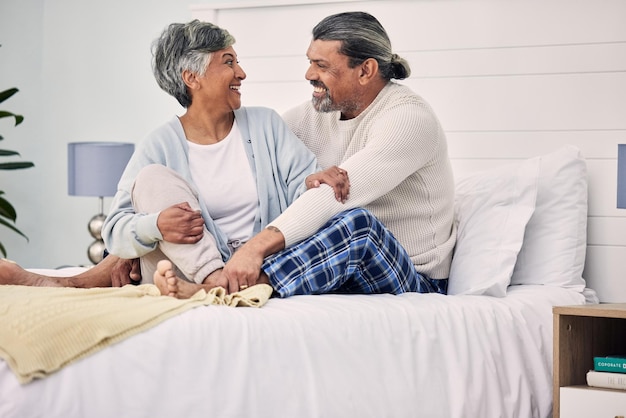 Old couple in bedroom together hug with love and comfort morning routine and happiness with bonding at home Retirement relax and communication marriage and life partner with people in bed