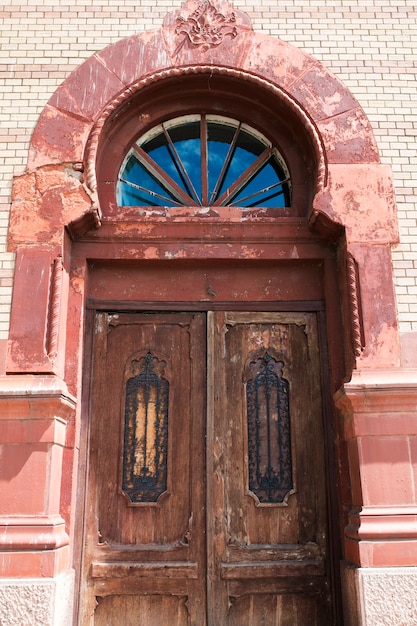 Old cracked door with glass and forging elements