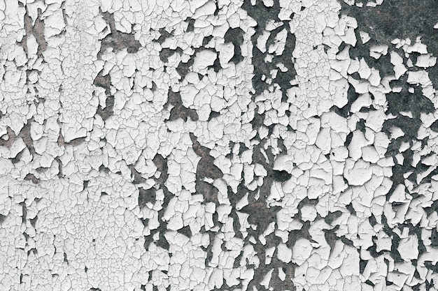 Photo old cracked paint texture. white paint on black surface.